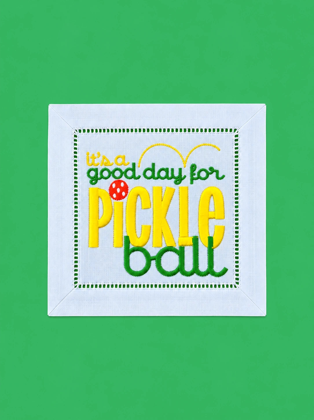 Embroidered pickleball cocktail napkin on a bright Kelly green background