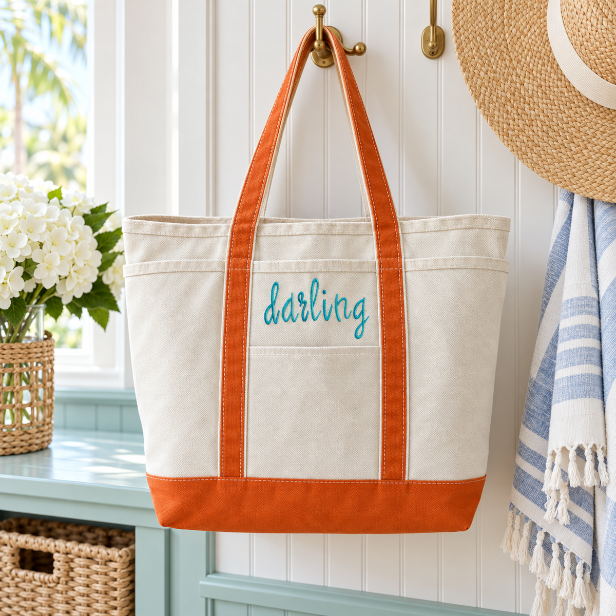 Orange-trimmed canvas darling tote hanging in a bright coastal mudroom