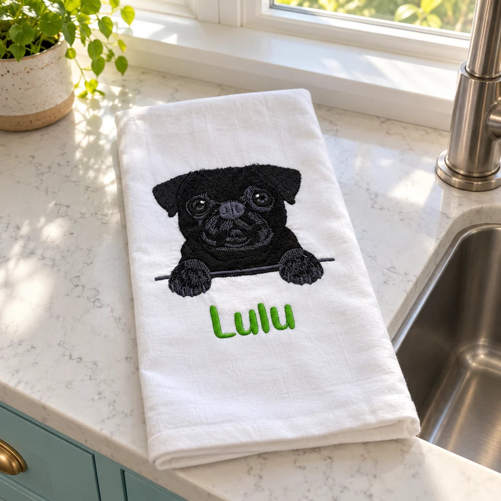 Lulu embroidered tea towel beside a kitchen sink and sunny window